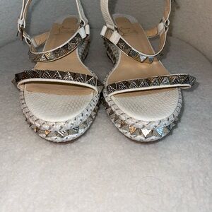 For sale: A pair of size 39 White Christian Louboutin wedges.
